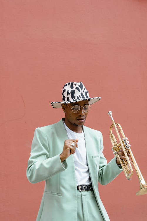 Free Man in Teal Suit Holding Trumpet Stock Photo