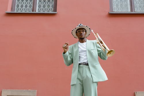 Man in Teal Suit Holding Trumpet