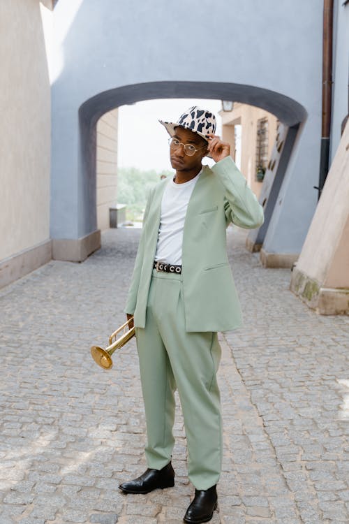 Free Man Wearing a Suit and Holding a Trumpet Stock Photo