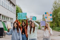 2 Women Holding Signage