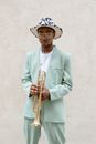 Man in Blue Suit Jacket Holding Trumpet