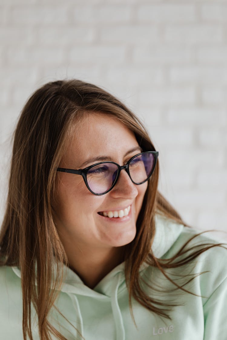 Woman In Green Hoodie Wearing Black Framed Eyeglasses