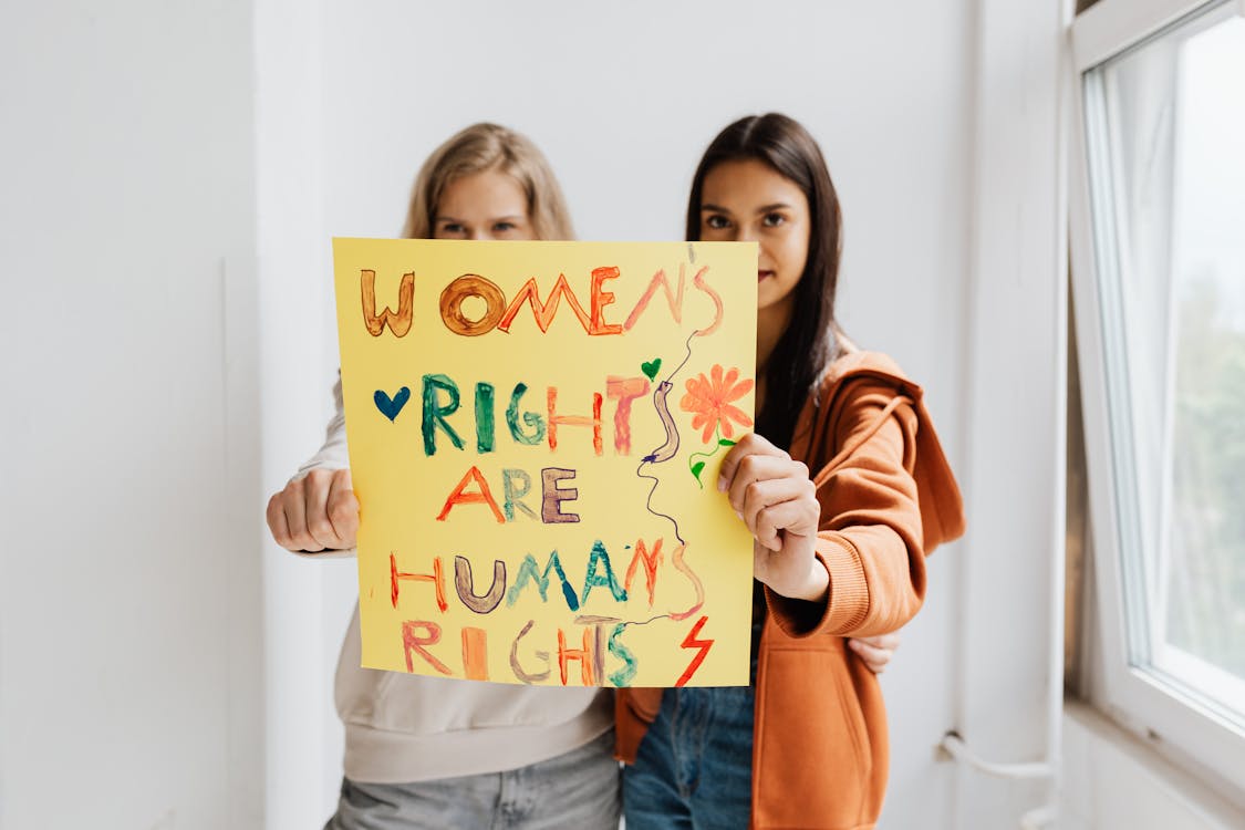 Free Women Holding a Poster Stock Photo