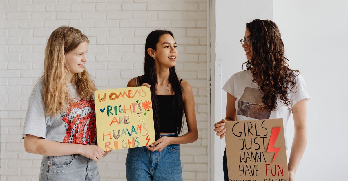 young fans holding signs supporting athlete social justice initiatives