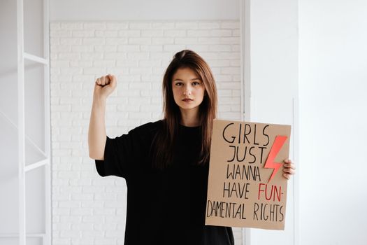 Woman in Black Crew Neck Shirt Holding a Cardboard