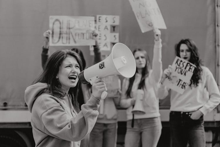 Grayscale Photo Of Woman Shouting Into A Megaphone