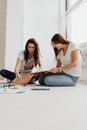 2 Women Sitting on Floor