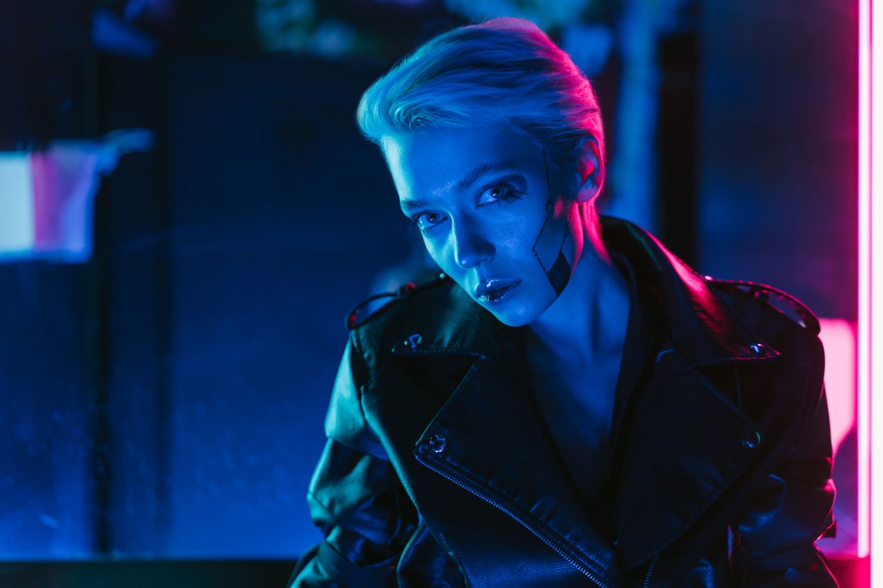 a striking portrait of a woman with cyberpunk makeup under vibrant neo