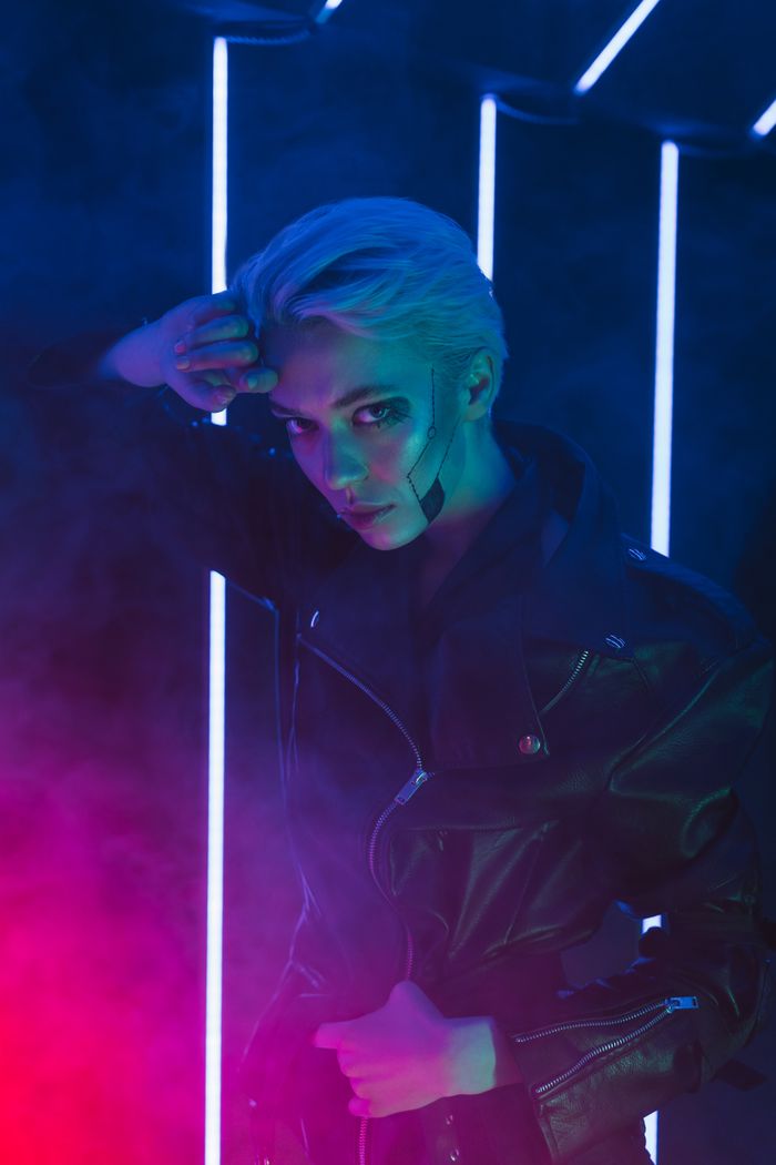 Player lit by cyan and magenta strip lights — photo by Mikhail Nilov on Pexels