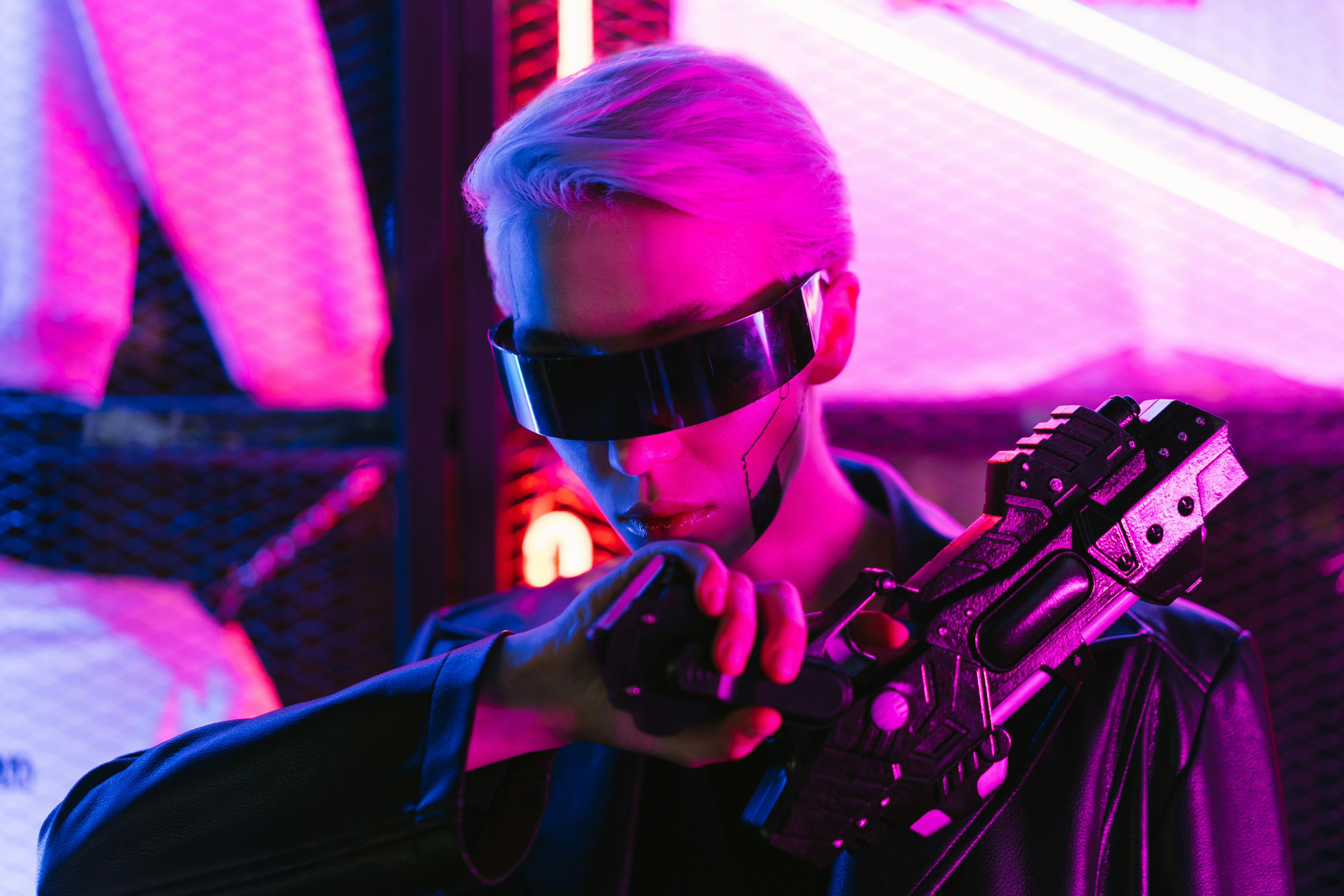 woman in black sunglasses holding black gun