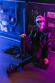 A futuristic model in cyberpunk attire and eyewear poses stylishly in vibrant neon lights.. pexels, futuristic, model