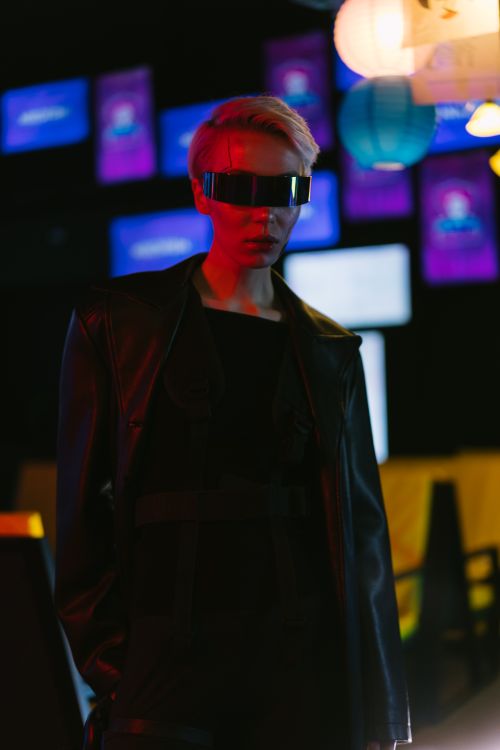 Free A fashion model in cyberpunk-themed attire and eyewear, shot indoors. Stock Photo