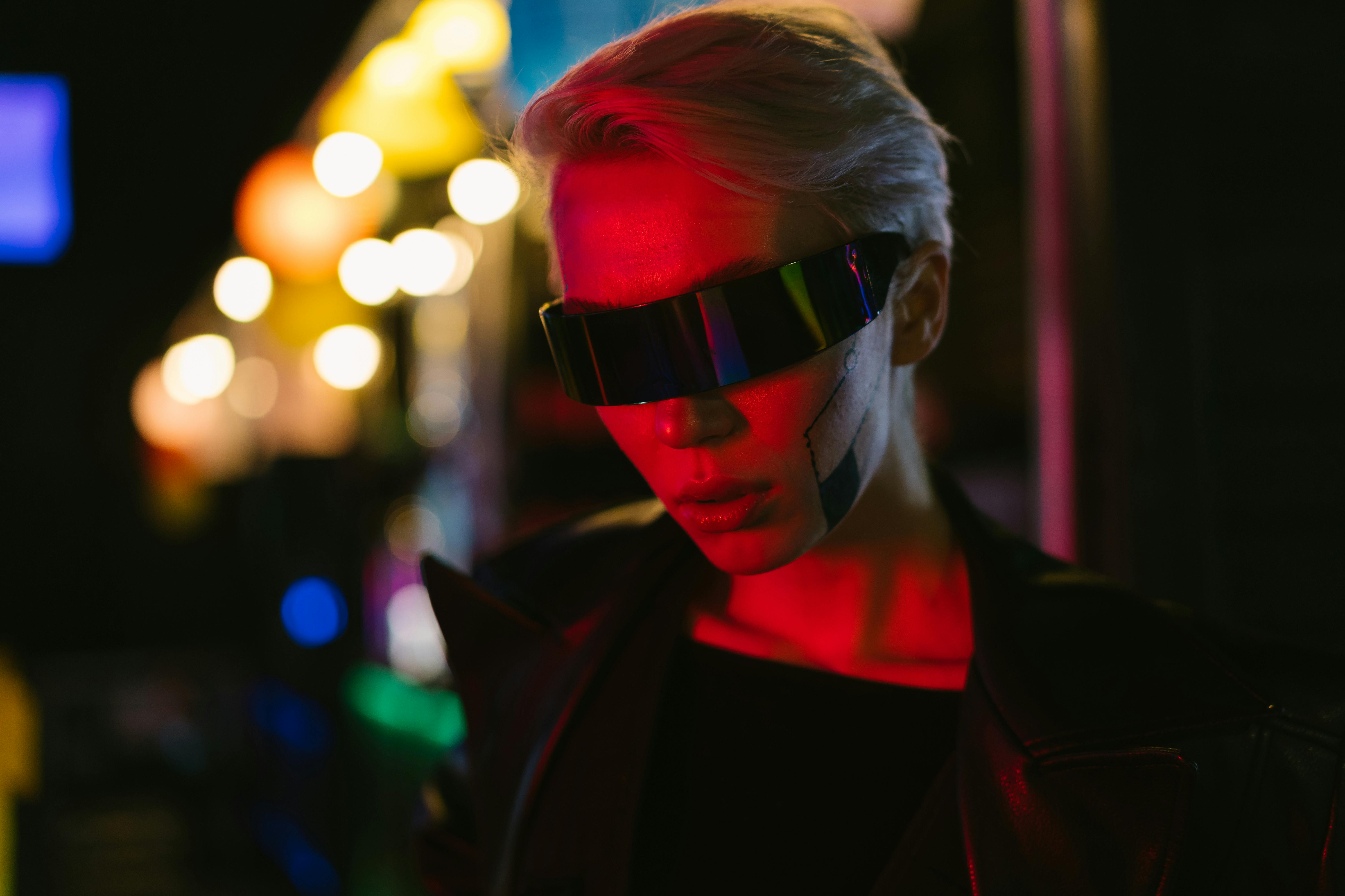 Cyberpunk woman in futuristic fashion with neon lighting and avant-garde eyewear.