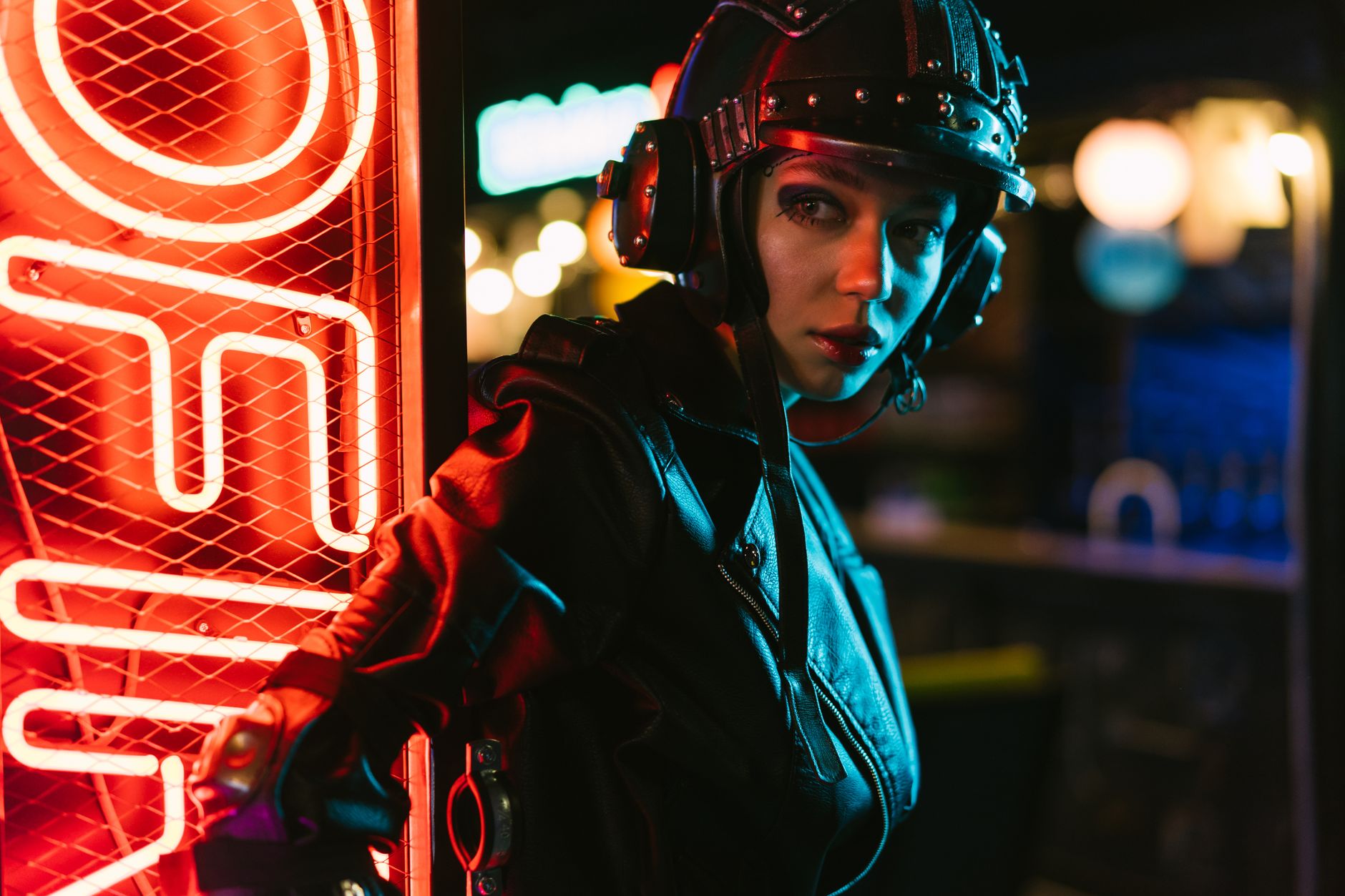A futuristic fashion portrait featuring a woman in cyberpunk style illuminated by neon lights.