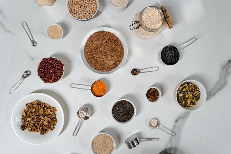 Assorted Dried Herbs And Spices Over A Marble Top Table