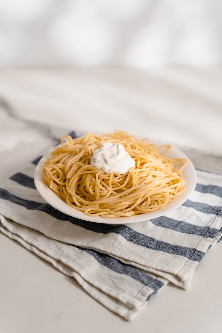 Pasta With White Sauce On Top  