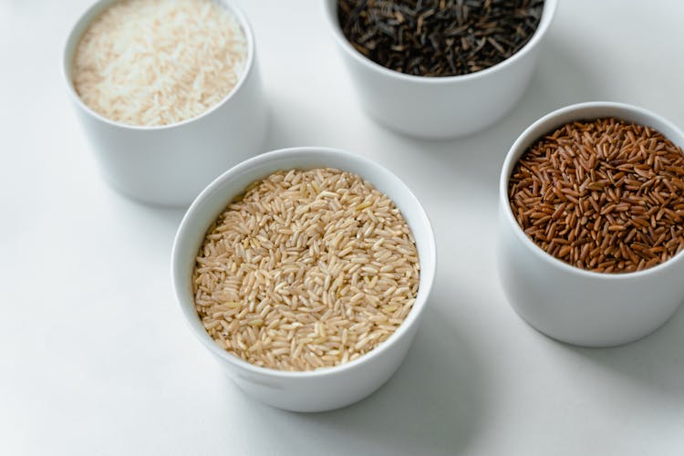 Close-Up Of Variety Of Rice In Bowls