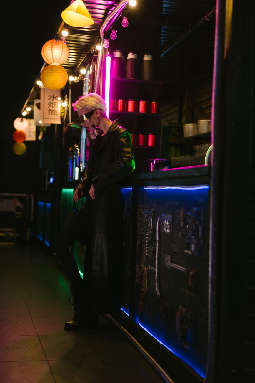 Stylish woman in a neon-lit cyberpunk bar setting, embodying futuristic fashion.. stylish, woman, neon
