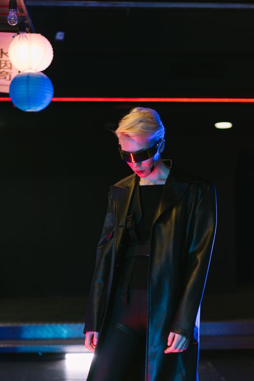 Free Blonde model in cyberpunk style with futuristic eyewear under neon lights. Stock Photo