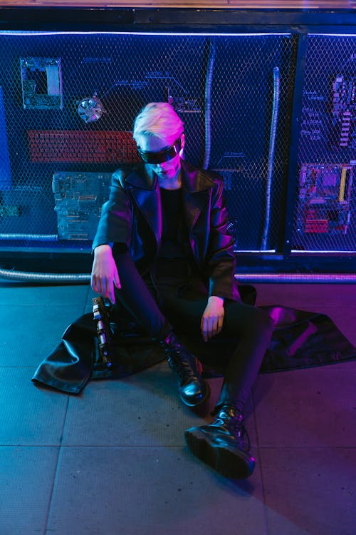 Woman in Black Leather Jacket and Pants Sitting on the Floor