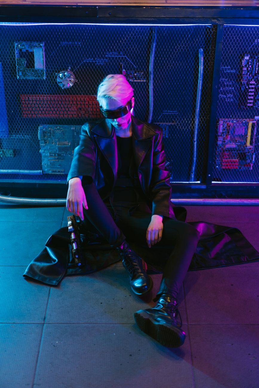 A futuristic fashion portrait of a person wearing cyberpunk eyewear, surrounded by neon lights.