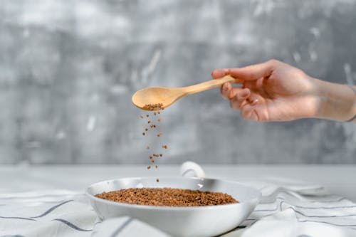 Free Using Wooden Spoon Scooping Grains  Stock Photo