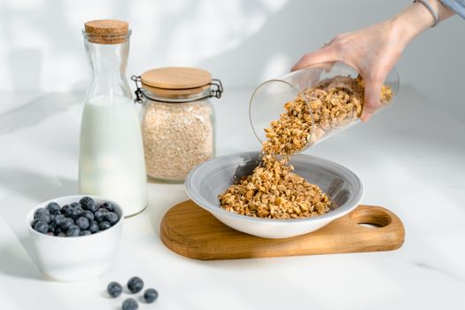 Pouring Granola in a Bowl