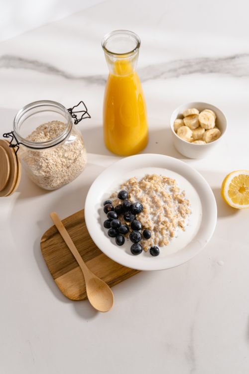 Free A nutritious breakfast including oatmeal, blueberries, banana, and orange juice. Stock Photo