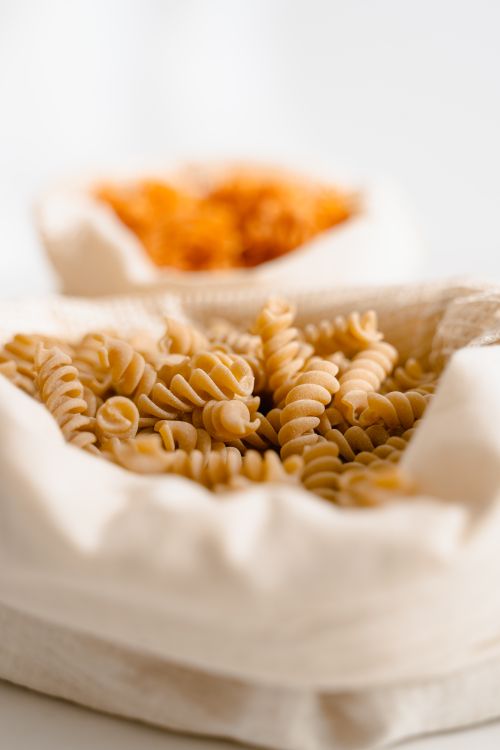 Free Close-up of rotini pasta in reusable bag showcasing sustainable food storage. Stock Photo