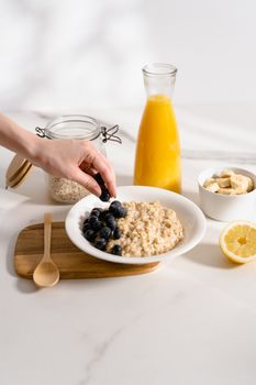 Person Holding Brown Wooden Bowl With Black Beans