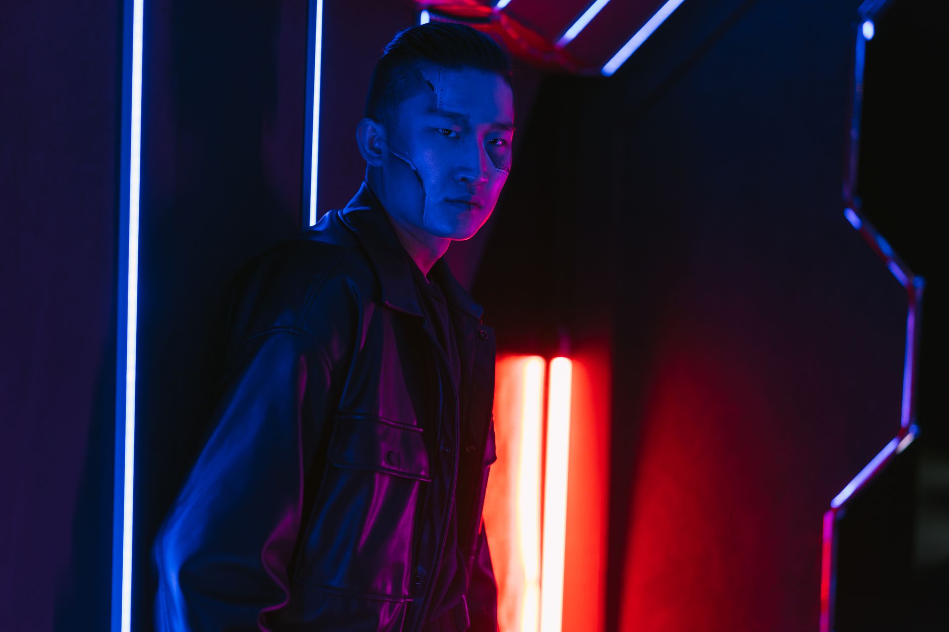 A man in a cyberpunk setting with dramatic neon lighting, exuding a futuristic vibe.