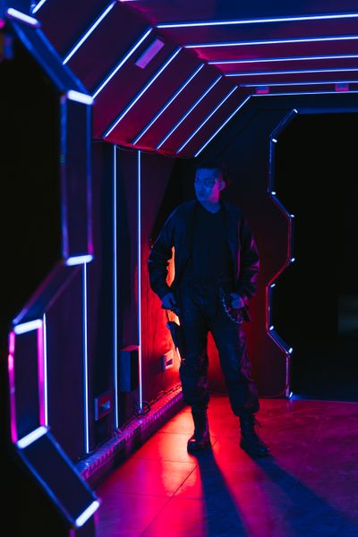 Man lit by vibrant neon lights, photo by Mikhail Nilov on Pexels