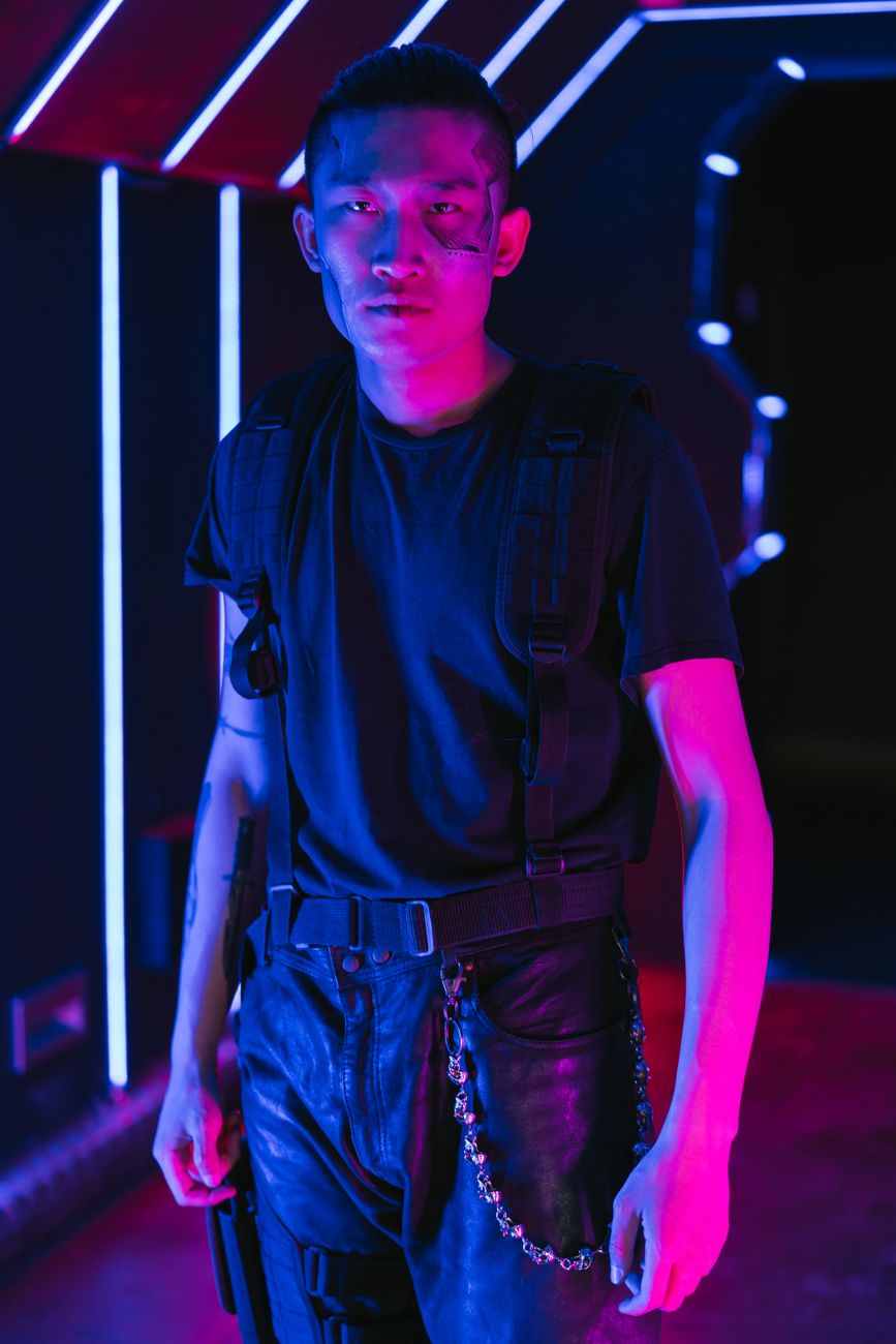 Stylish portrait of a man in a futuristic, neon-lit setting, embodying cyberpunk fashion.
