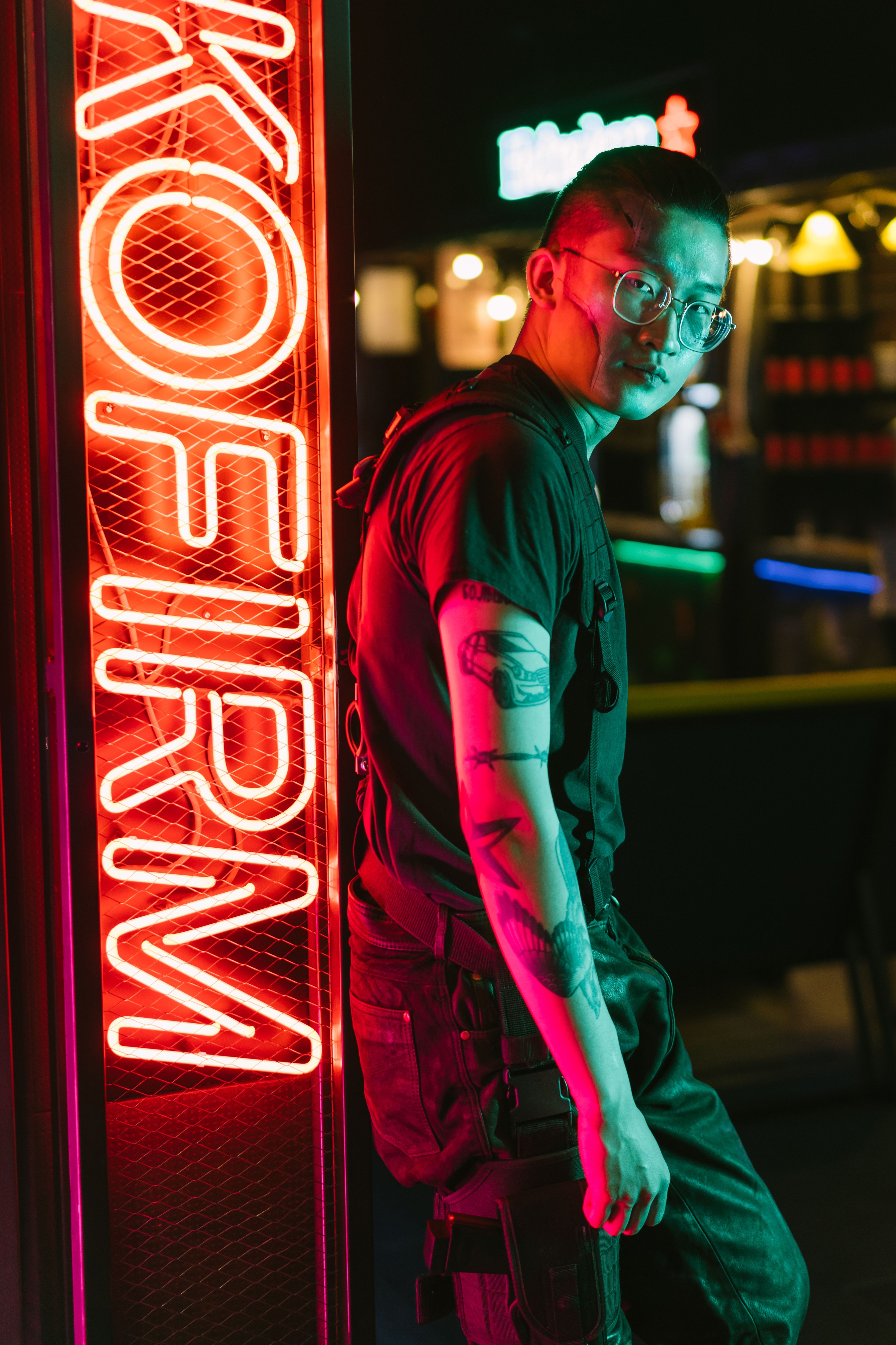 A stylish portrait of a man in neon cyberpunk fashion against a vibrant city night backdrop.. pexels, stylish, portrait