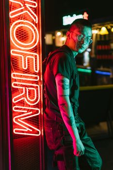 A stylish portrait of a man in neon cyberpunk fashion against a vibrant city night backdrop.. pexels, stylish, portrait