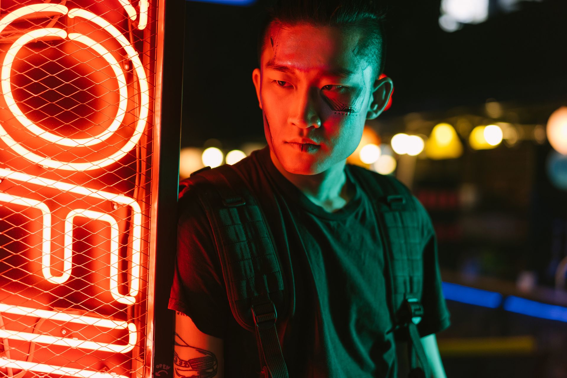 A stylish portrait of a man in a cyberpunk setting illuminated by neon lights, exuding cool futuristic vibes.