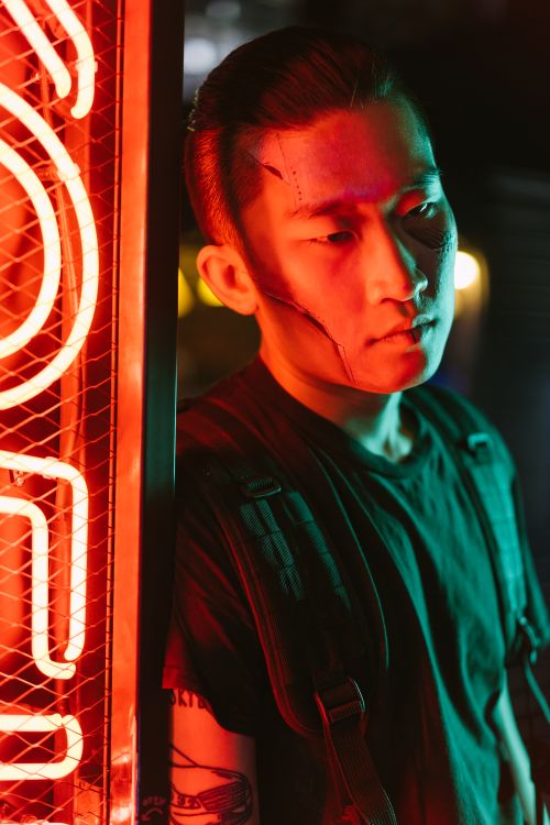 Neon-lit player in a dark room — photo by Mikhail Nilov on Pexels
