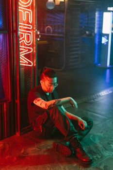 Asian man in futuristic neon setting portraying cyberpunk fashion and style.. asian, futuristic, neon