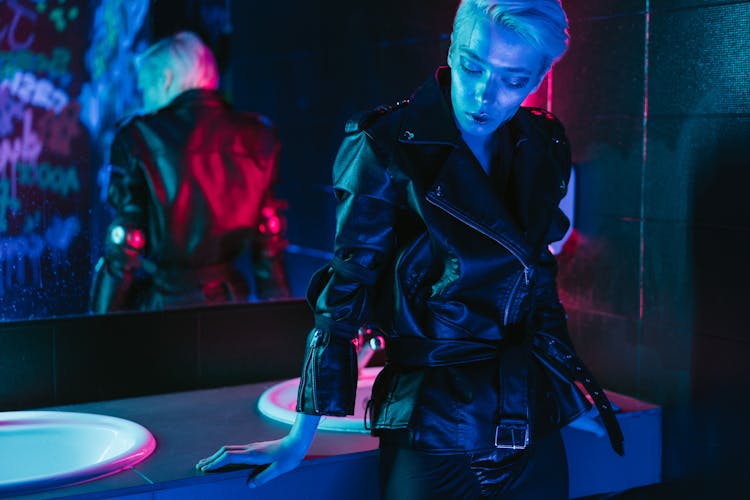 A Person In Black Jacket Standing Beside Sink