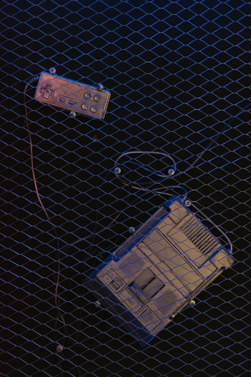 Video Game Console Hanging on a Wire Mesh