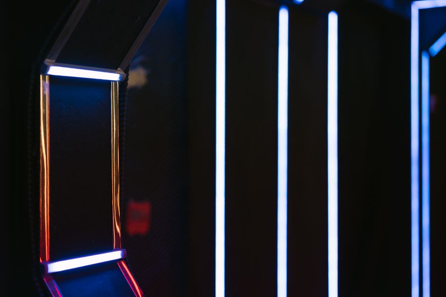 A dark corridor lit by thin lines of light