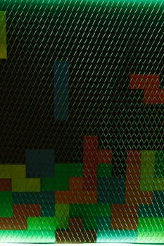 Vibrant geometric shapes on wire mesh create a Tetris-inspired retro design.