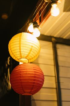Captivating nighttime shot of illuminated paper lanterns with a cozy warm glow.