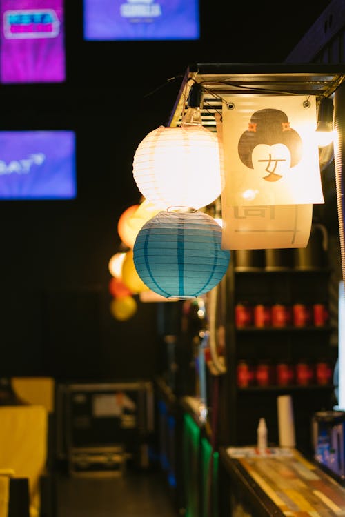 Paper Lanterns Hanging Beside String Lights