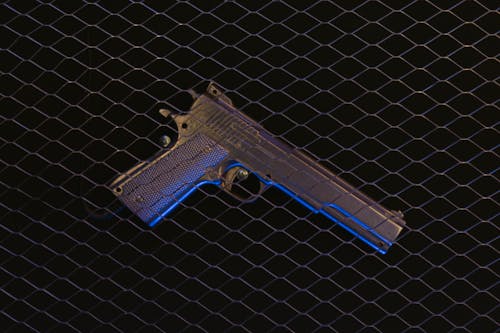 Free Pistol on a Black Surface  Stock Photo