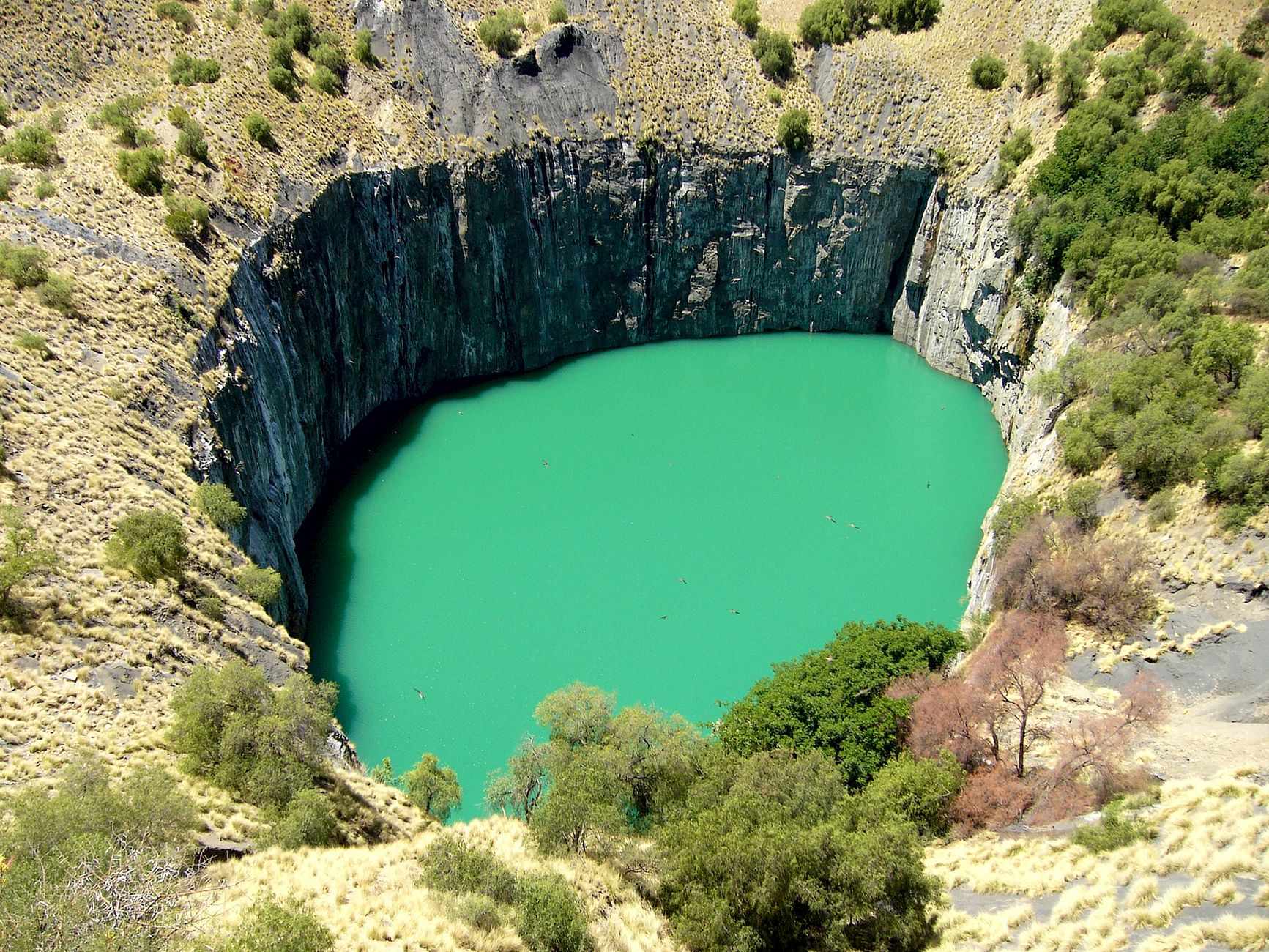 Stunning aerial photograph of the iconic Big Hole in Kimberley, showcasing the unique turquoise water and surrounding rock formations.