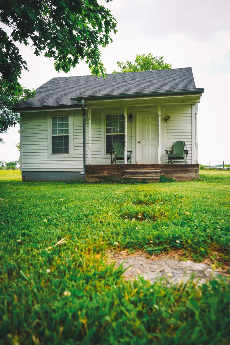 Tiny home with porch and green yard