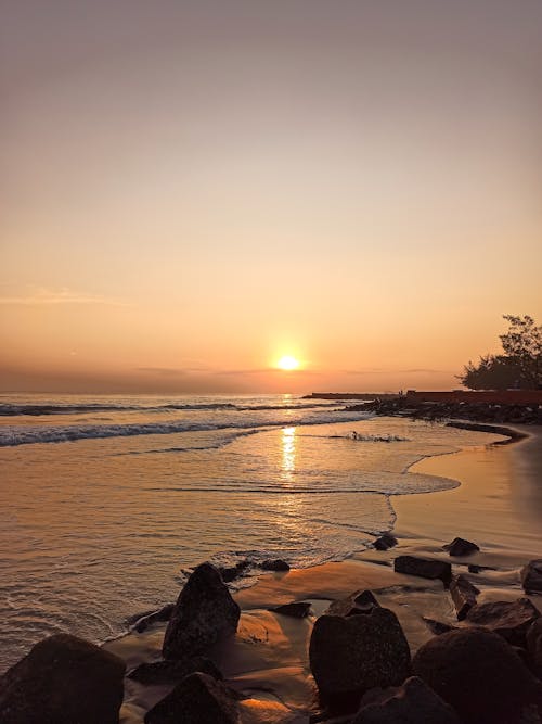 Crashing Waves on Shore During Sunset