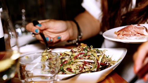 Person Eating Vegetable Dish