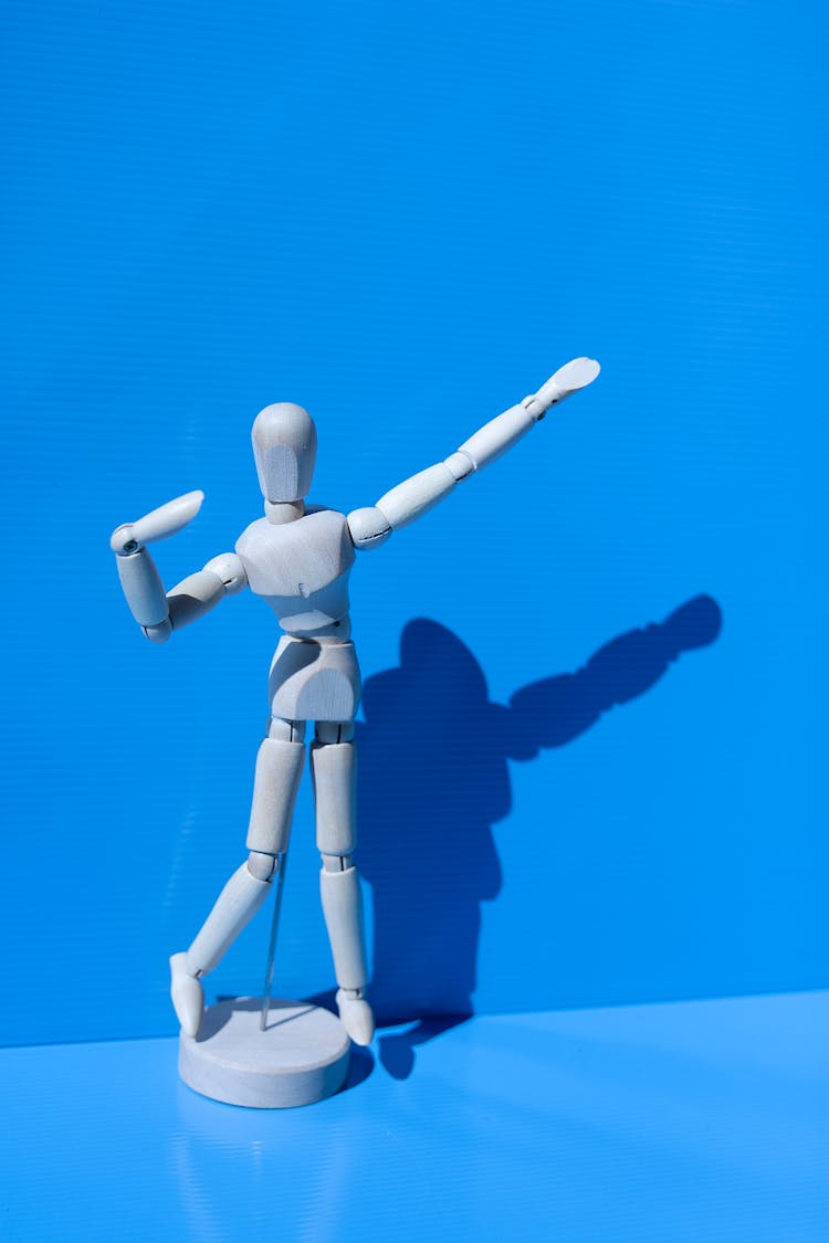 Wooden Drawing Mannequin On Blue Background